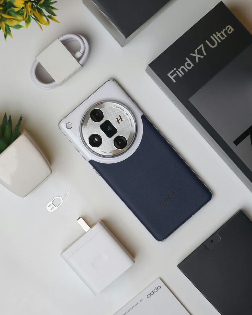 Flat lay of Oppo Find X7 Ultra smartphone with accessories on white background.